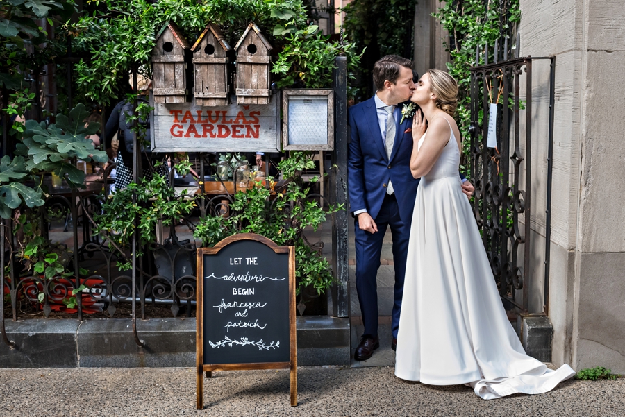 A newly married couple kiss outside of Talula's Garden in Philadelphia